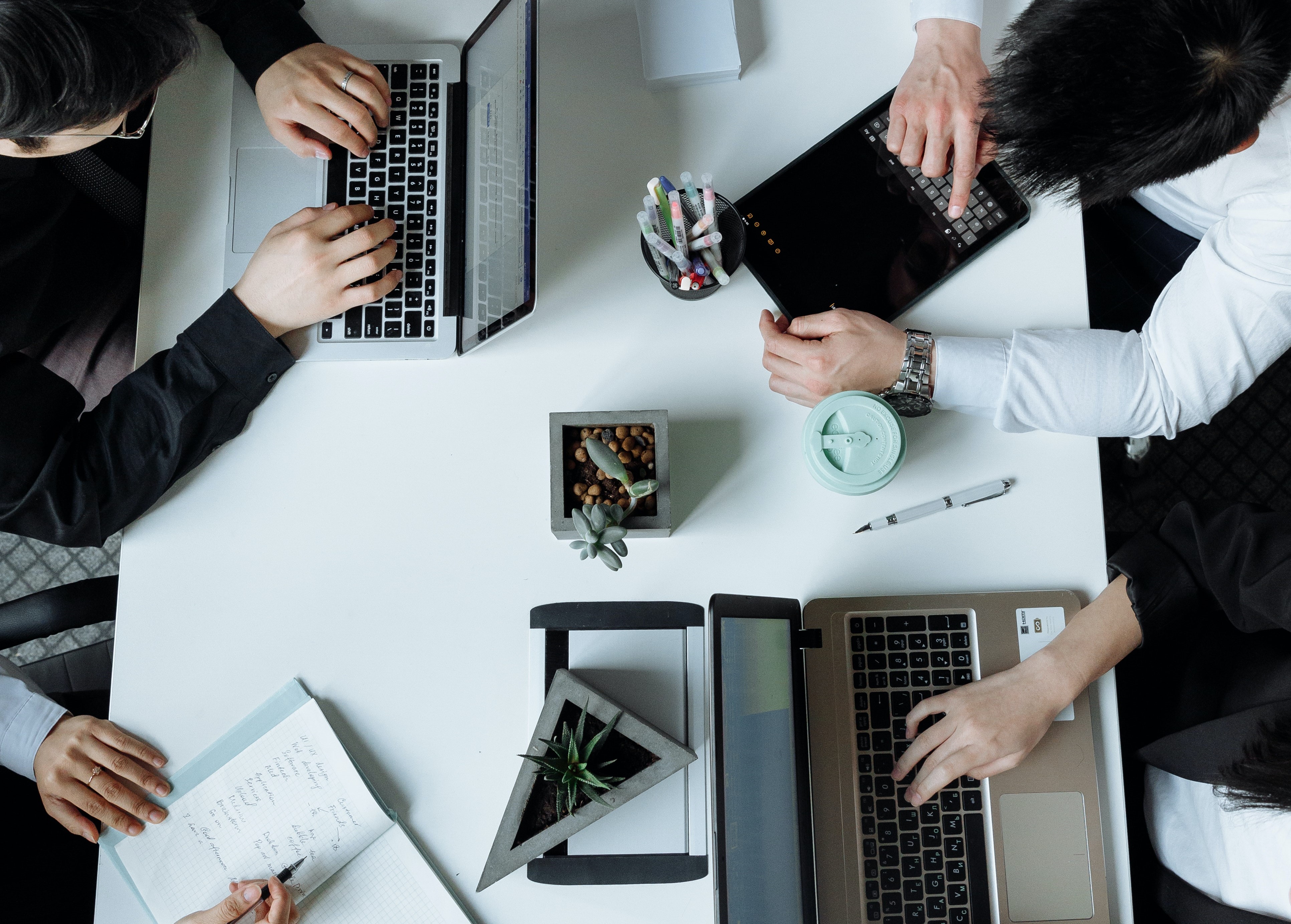 group sitting at desk with computers